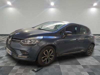 the grey car is parked on a checkered tile floor