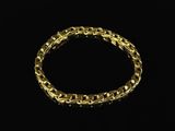 a gold bracelet on a black background