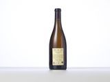 a bottle of white wine sitting on top of a table