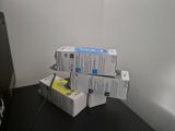 four boxes of ink sitting on a desk next to a computer
