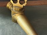 a brass pipe that is sitting on the floor