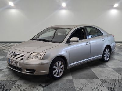a silver car parked in a room with checkered floor