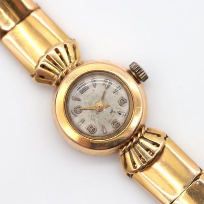 an image of a close up of a wrist watch on a white surface