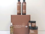 trois bouteilles de produits Purehousee posées sur un carton