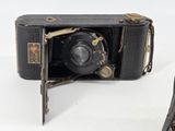 a black camera sitting on top of a white table