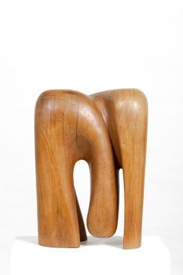 sculpture of a wooden elephant on a white pedestal