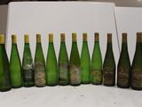 bottles of wine are lined up in a row on a table