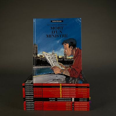 books stacked on top of each other with a man reading a newspaper
