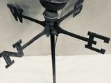 a black and white photo of a weather vane