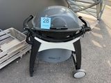 a grill with a price tag on it sitting on the ground