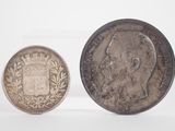 two silver coins, one with a crown and the other with a crown on it