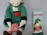 a small stuffed toy sitting next to a book