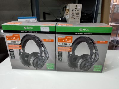 two boxes of headphones sitting on top of a table