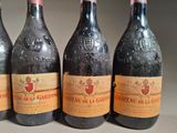 four bottles of wine are lined up on a table
