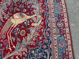 an image of a red rug with a bird design on it