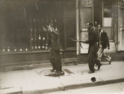 a black and white photo of a group of men on the street