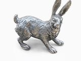 an image of a silver rabbit figurine on a white background