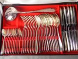 a red box with silverware in it on a table