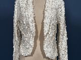 a white sequinned jacket on a mannequin mannequin mannequin mannequin mannequin mannequin mannequin mannequin