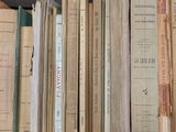 a lot of books that are stacked on a shelf