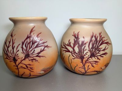 two vases that are sitting on a table