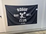 a sign that says rogue bar and bell club hanging on the wall