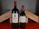 two bottles of wine sitting next to each other on a table