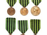 a group of six medals and a medal on a white background
