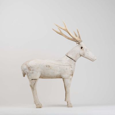 sculpture of a white deer with antlers on it ' s head