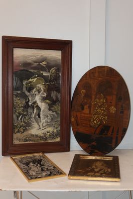 two framed pictures on a table next to a picture of a dog