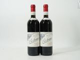 two bottles of red wine sitting next to each other on a white surface