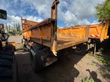 a dump truck that is parked on the side of the road