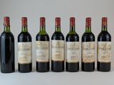 six bouteilles de vin sont alignées sur une table