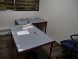 a desk with a chair and a computer on it