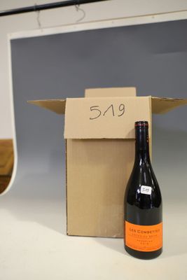 a bottle of wine sitting in a box on a counter