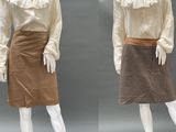 two mannequins dressed in white shirts and brown skirts