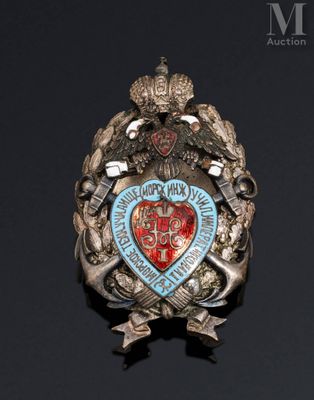 a badge on a black surface with a red heart on it