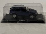 a toy car in a clear box on a white surface