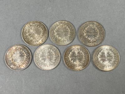 a group of six silver coins sitting on top of a table