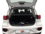 the back of a white car with its trunk open and a laptop in the trunk