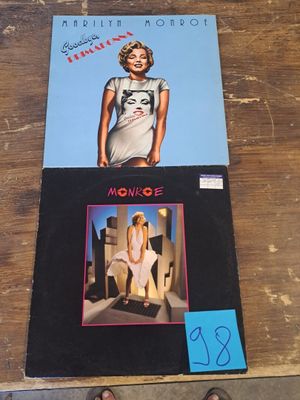the album covers for the album are on a wooden table