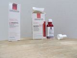 a bottle of lotion sitting on a table next to a box of lotion