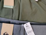 two pairs of men ' s pants with a price tag on them