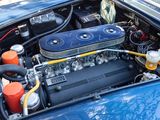 a blue car with an engine in the trunk of it