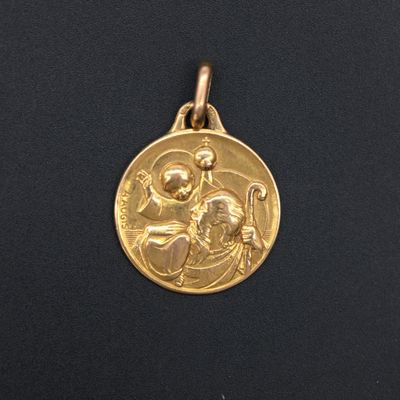 a close up of a gold medal on a black surface
