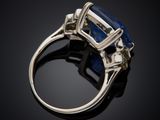 a blue sapphire and diamond ring on a black background