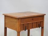 a small wooden table with a drawer on top of it