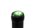 a bottle of wine with a green label on it