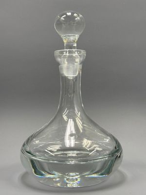 a clear glass decanter with a glass stopper