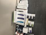 a stack of makeup products on a shelf next to a toilet